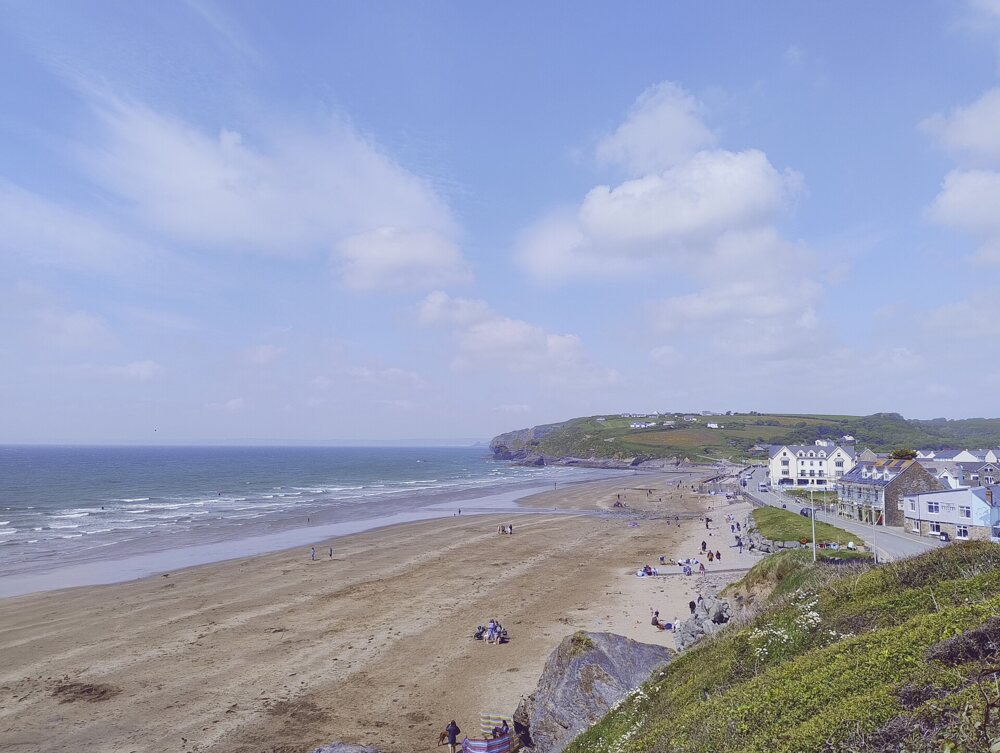 Beach with a village of light-colored houses in the background